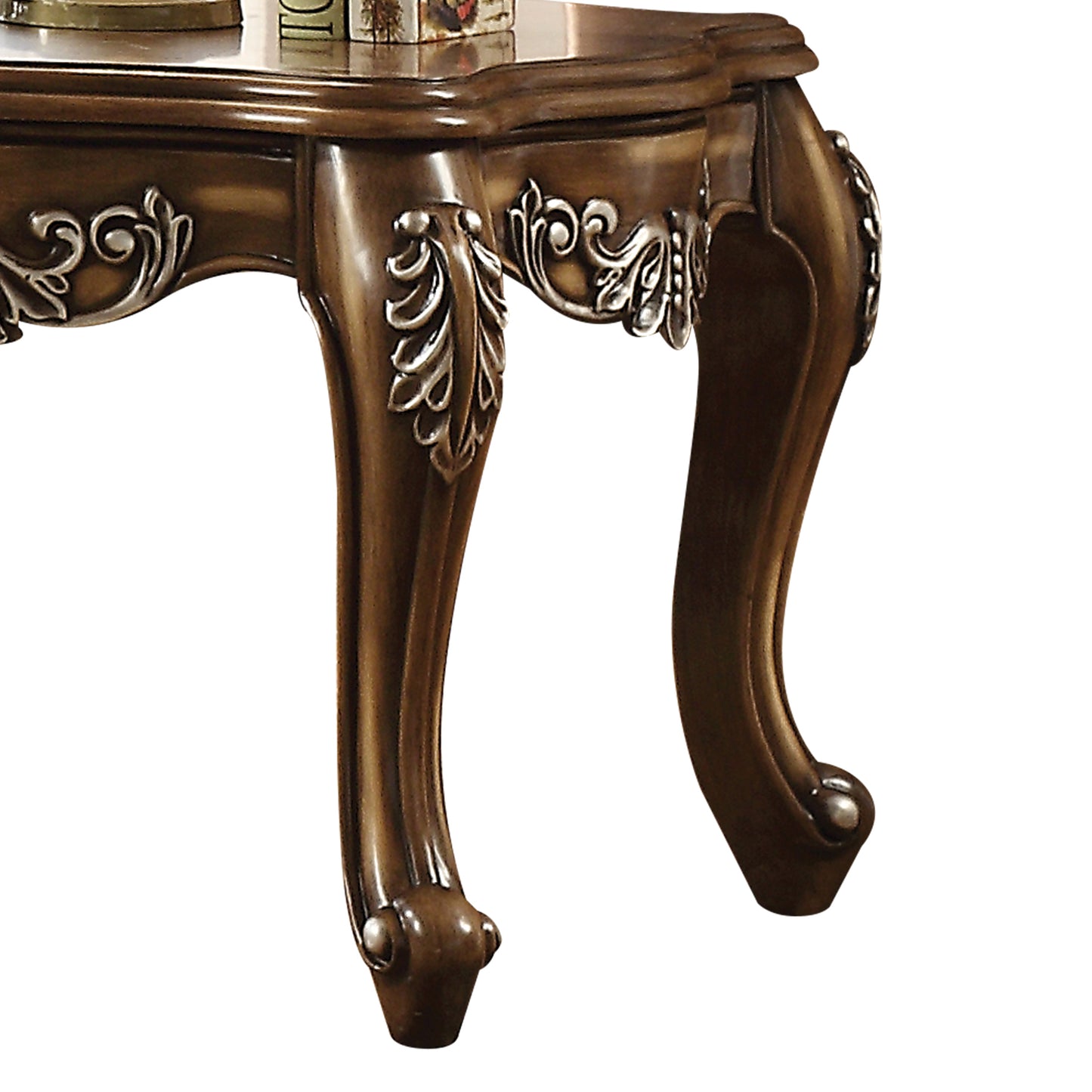 Ornate dark wood cabriole leg detail on antique end table