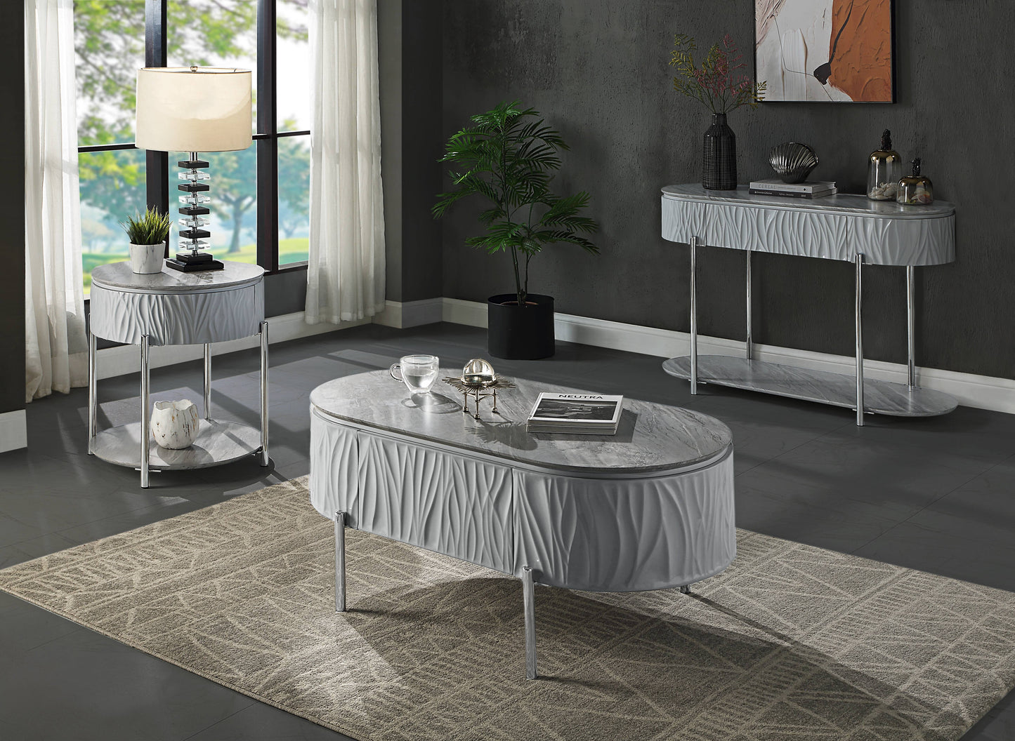 Oval carved grey coffee table with faux marble top and chrome legs