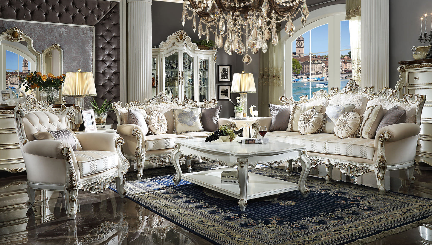 Luxurious ivory velvet sofa with ornate gold trim and plush decorative pillows