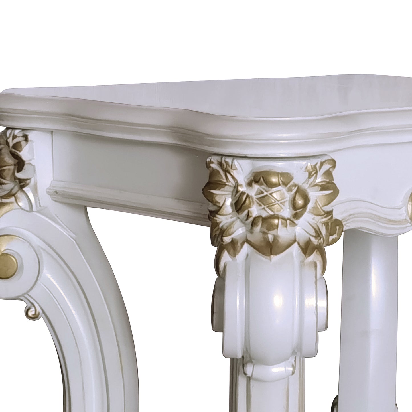 White carved wood console table with ornate gold accents