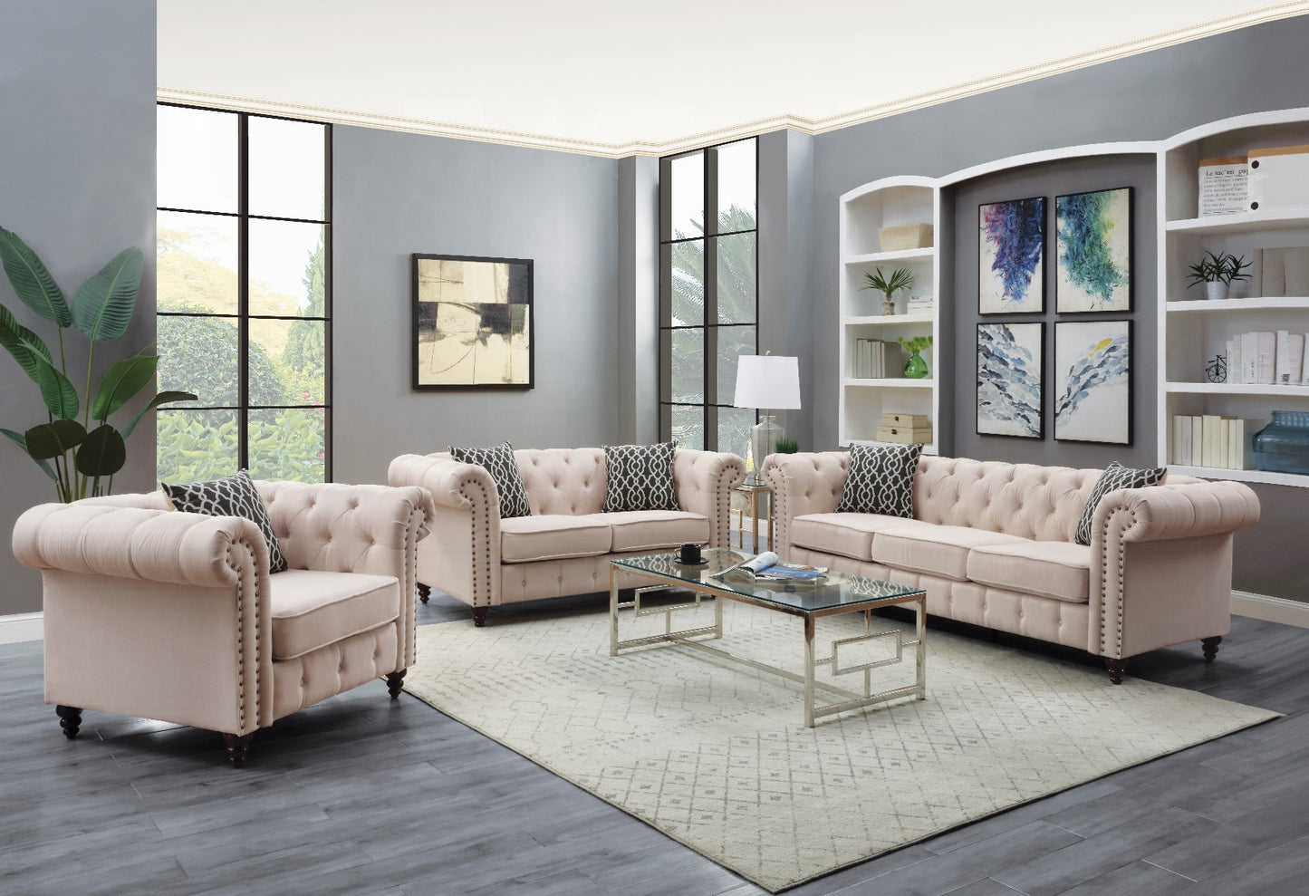 Tufted blush pink velvet Chesterfield sofa with silver nailhead trim and geometric accent pillows