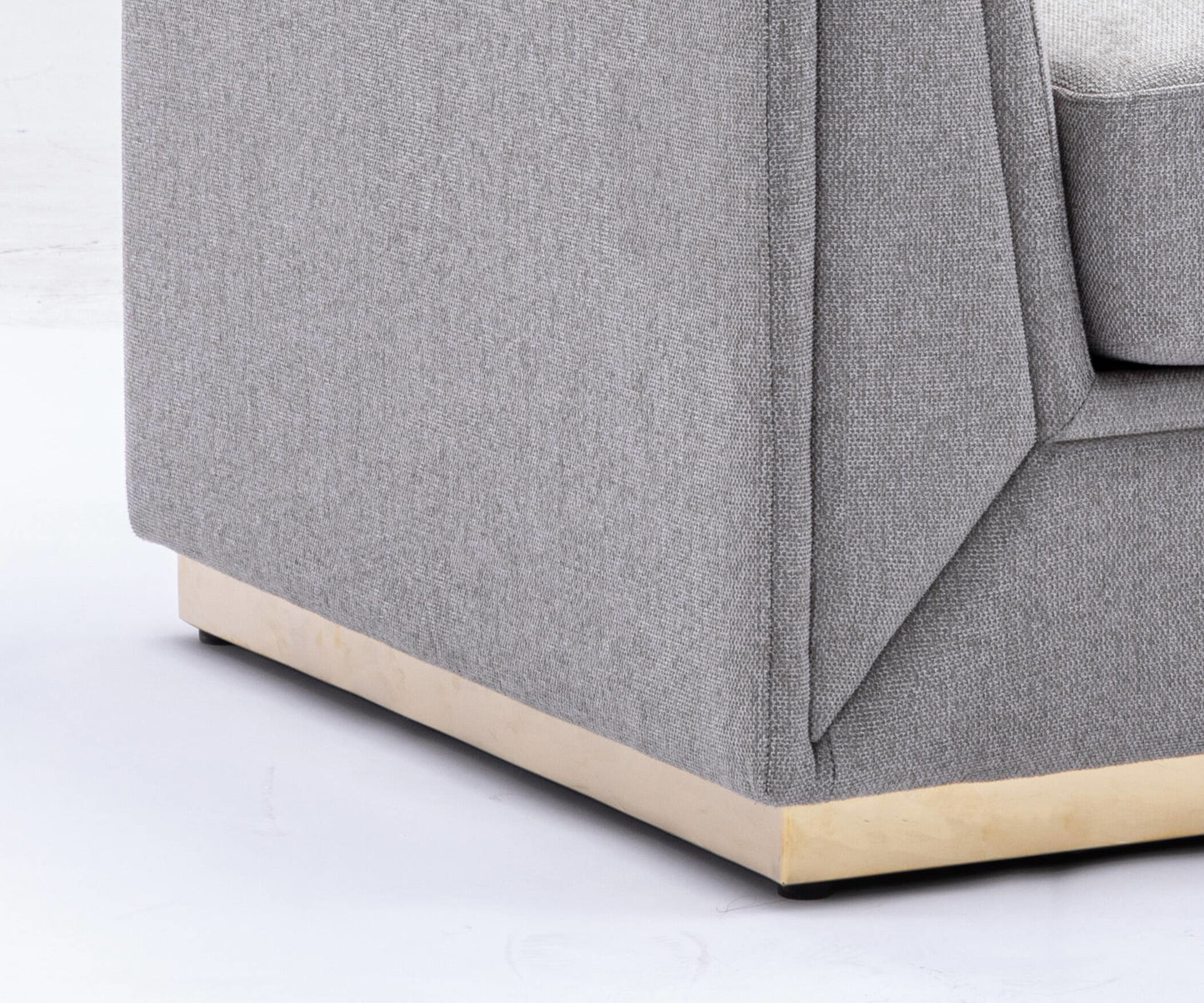Closeup of a grey textured fabric sofa arm with a light wood base
