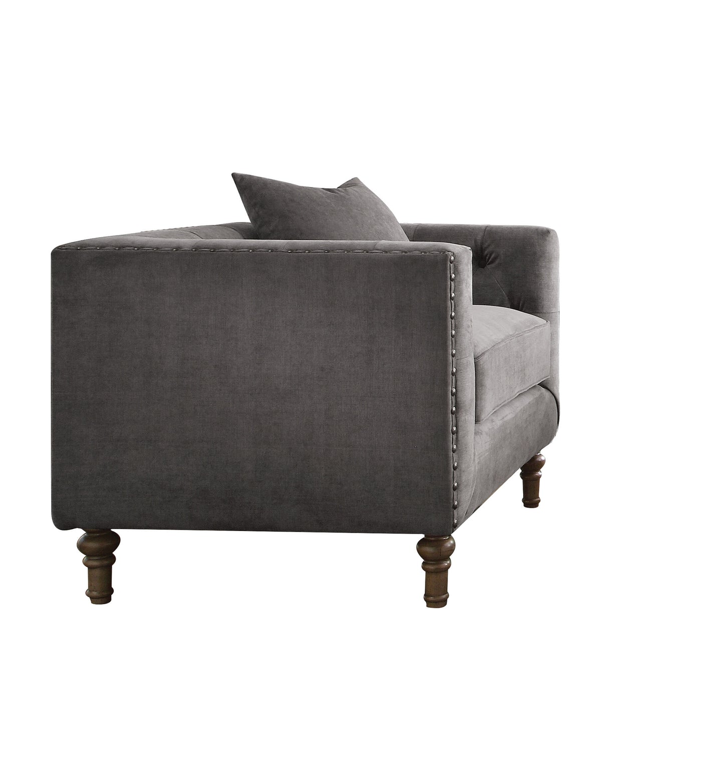 Dark gray velvet armchair with tufted back and nailhead trim accent