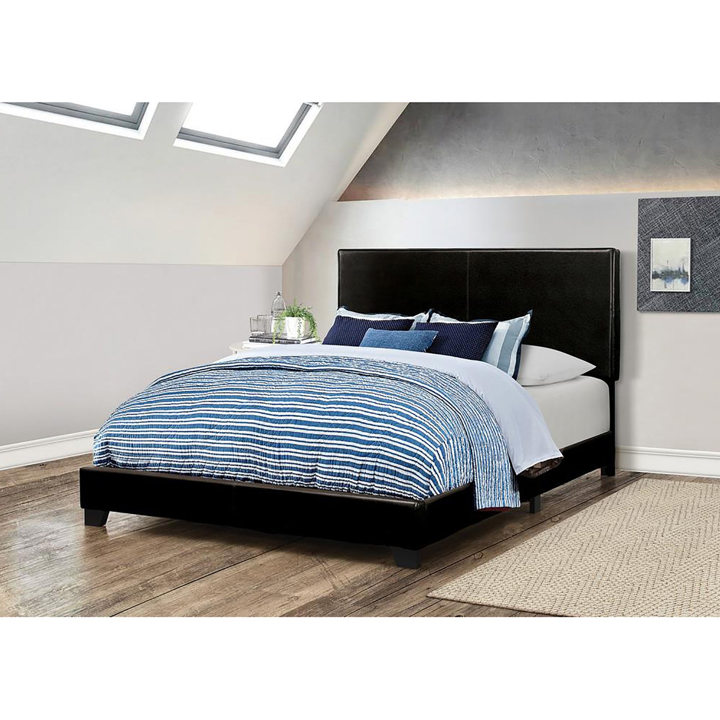 Black faux leather platform bed with blue striped bedding and dark wood floors