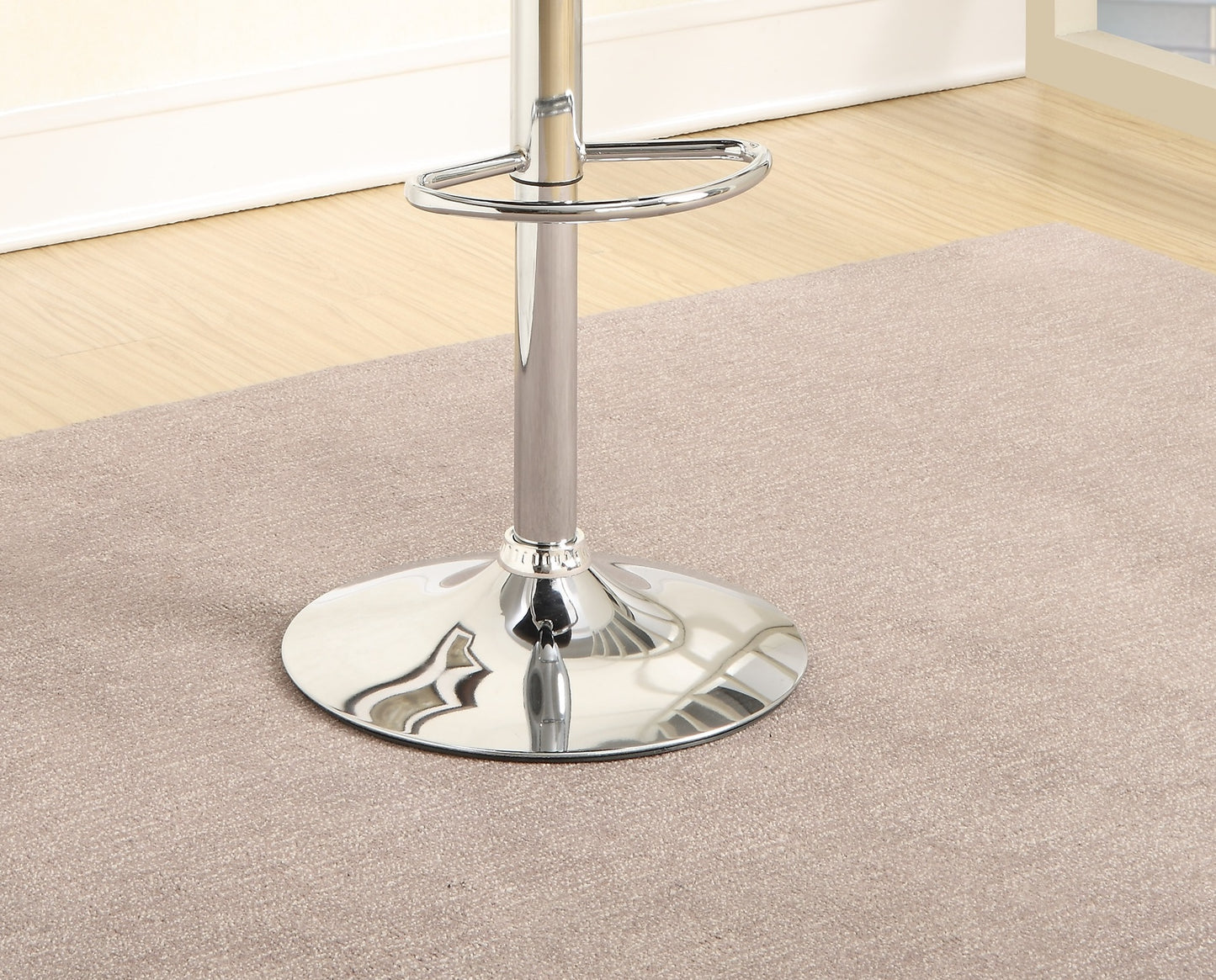 Chrome adjustable bar stool base with footrest ring on neutral carpet