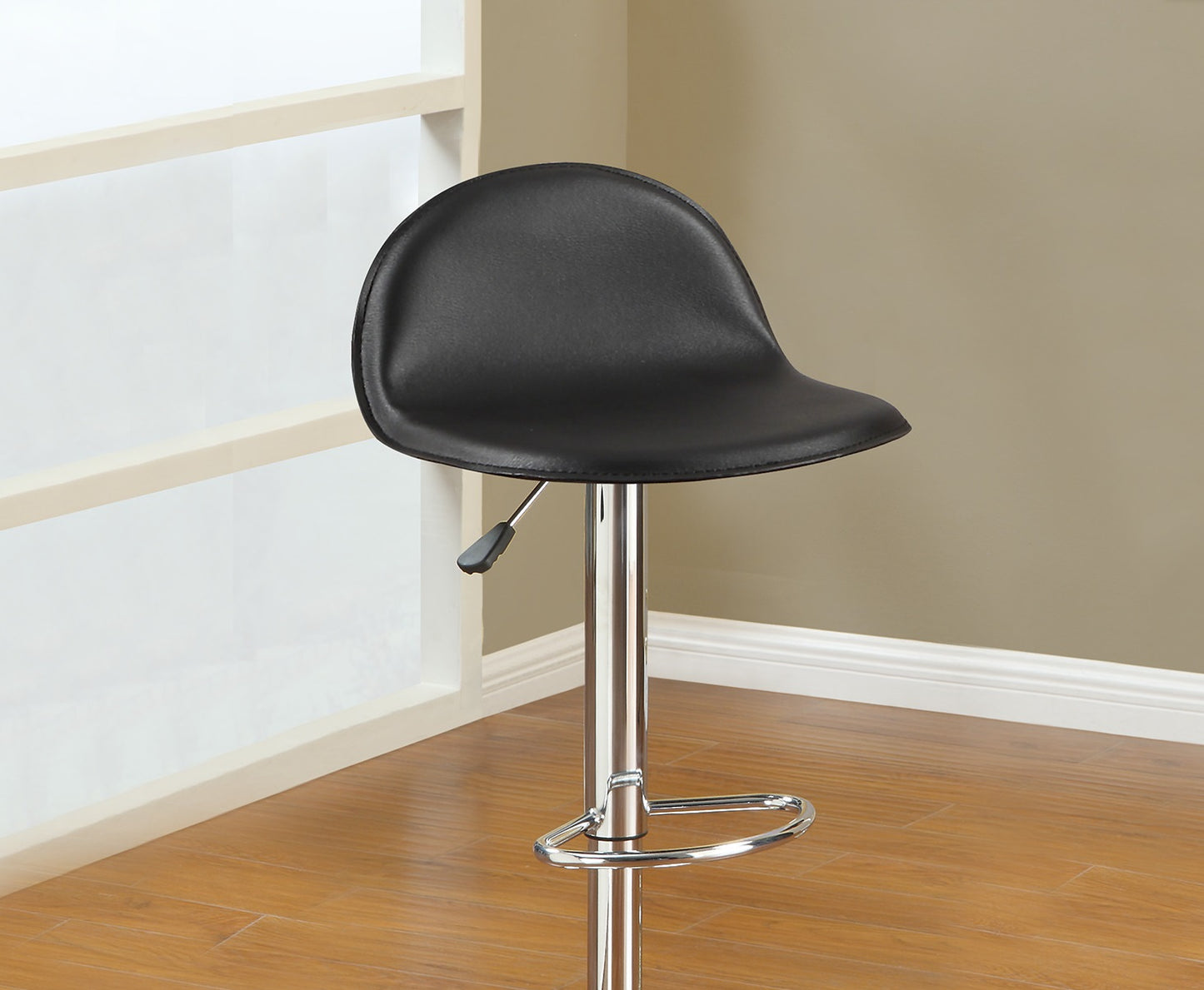 Black leather bar stool with adjustable height and chrome base