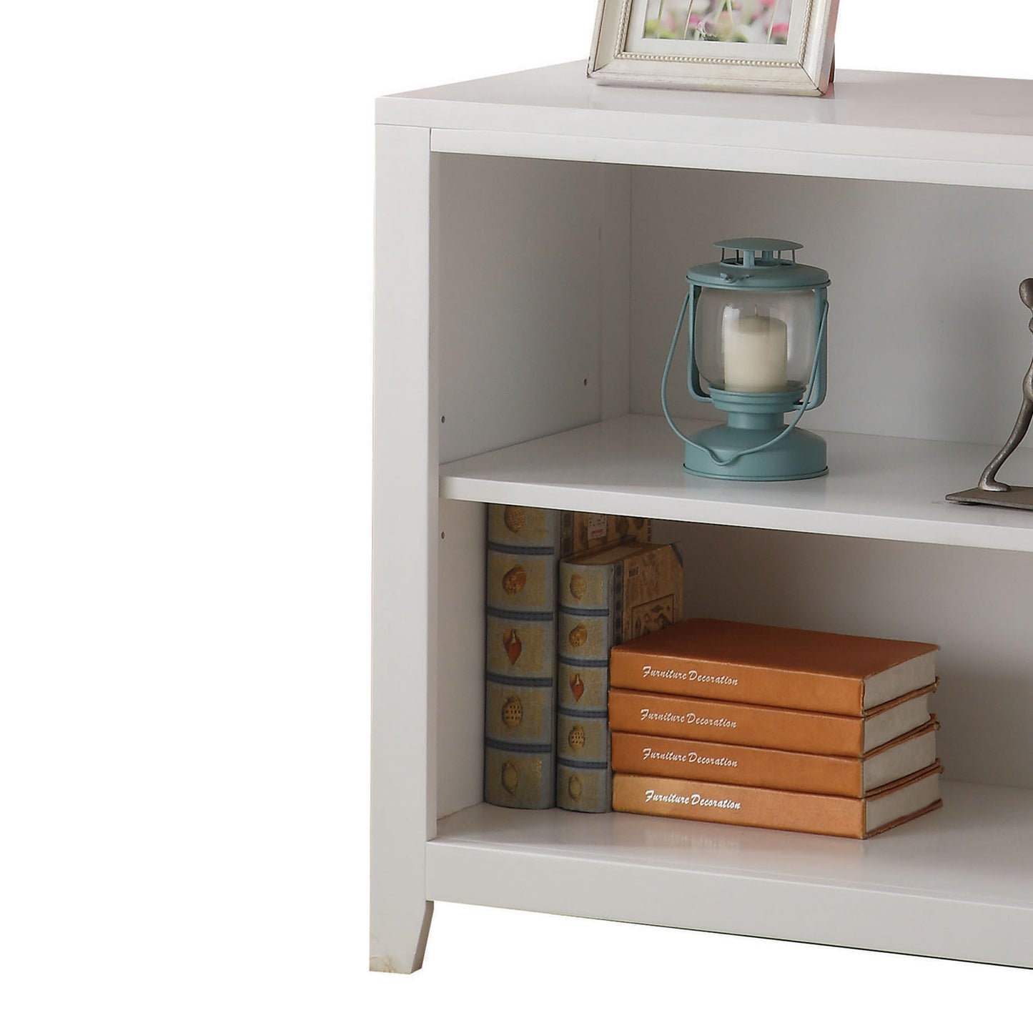 White bookshelf with decorative books and teal lantern centerpiece
