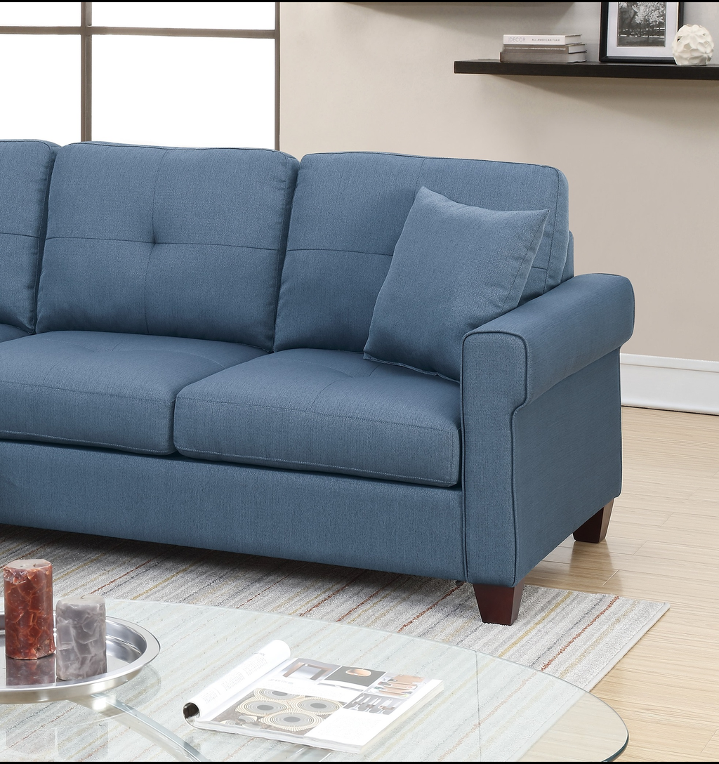 Modern blue upholstered sofa with tufted cushions and one accent pillow