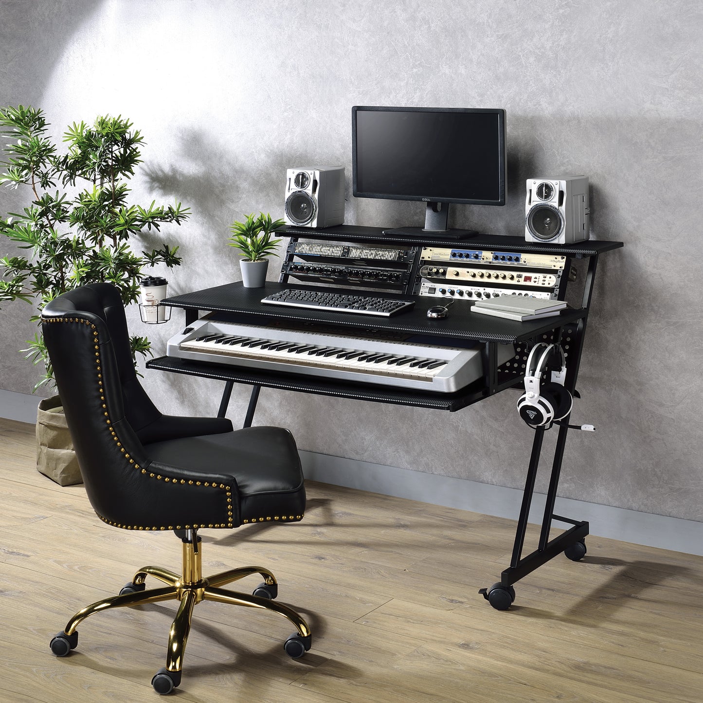 Black leather studio chair with gold accents and casters