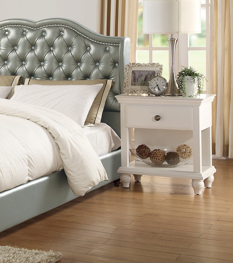 Silver tufted headboard with crystal accents and a soft blue bed frame