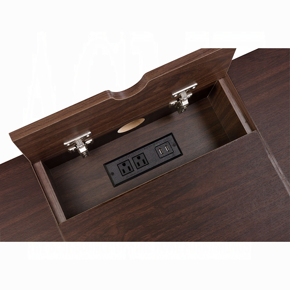 Dark wood desk with builtin power outlet featuring USB and AC ports for charging devices