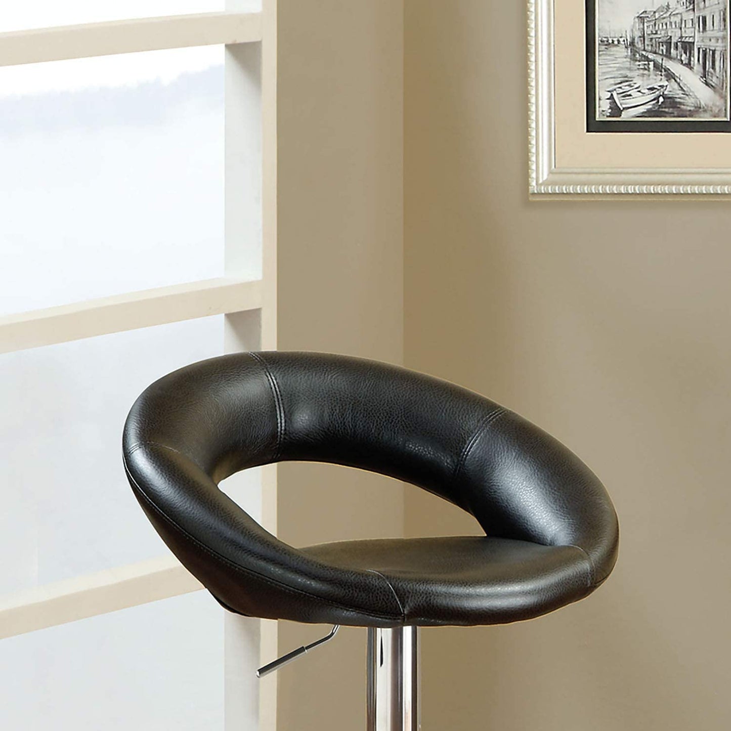 Black leather bar stool with chrome base a stylish addition to any modern kitchen