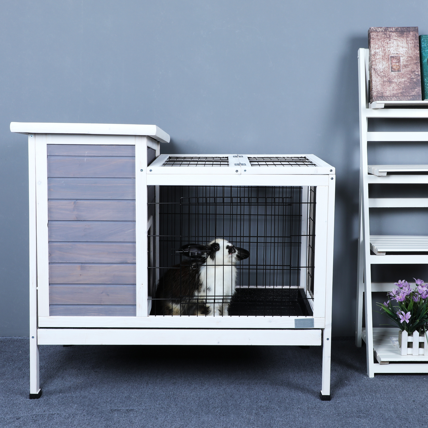 Wooden rabbit hutch with grey paneling and wire cage interior