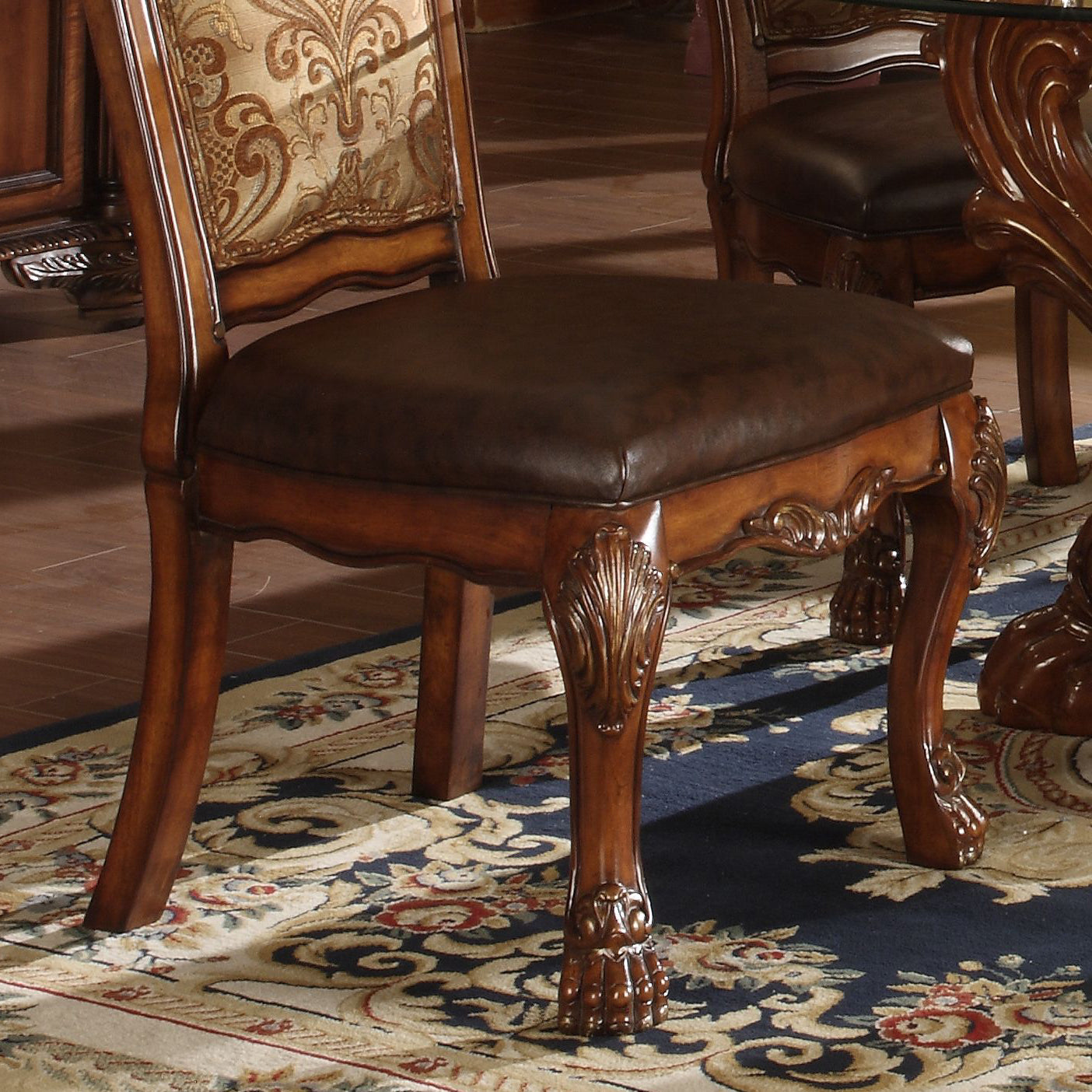 Ornate wood dining chair with carved legs and patterned upholstery