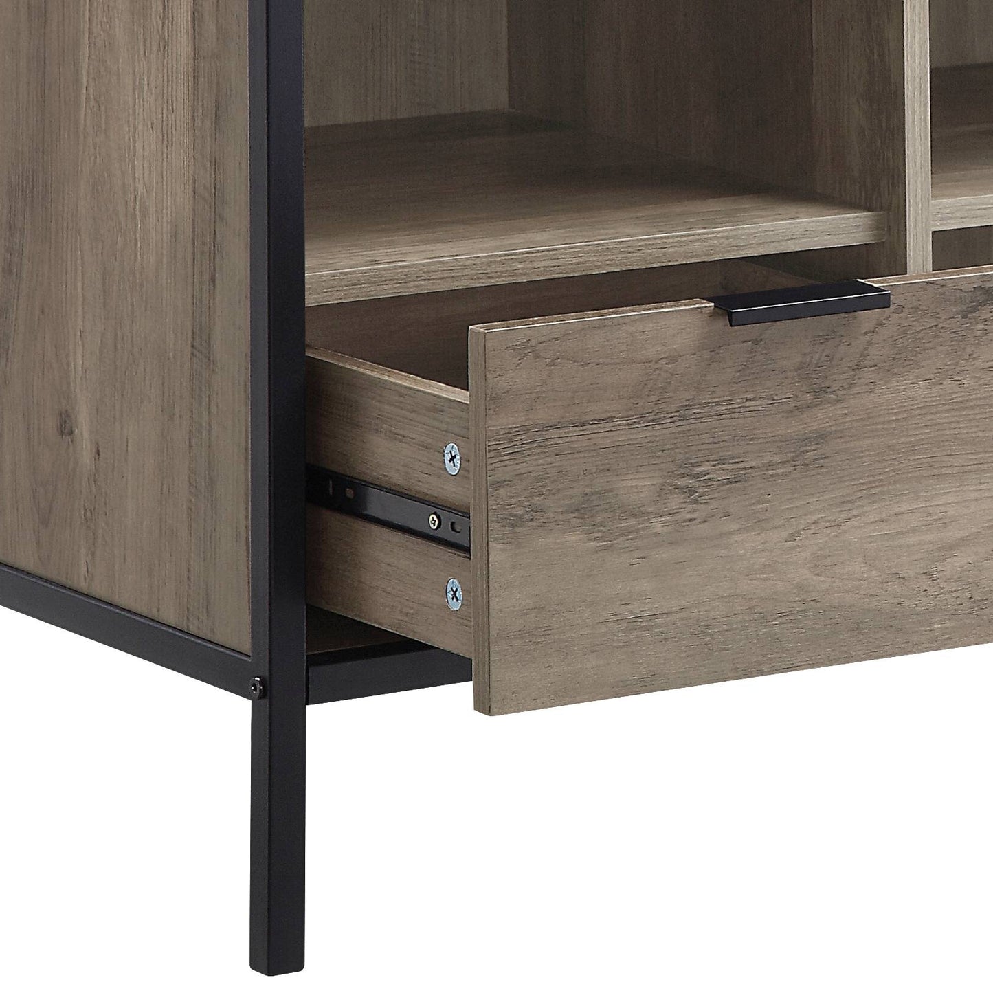Closeup of distressed wood grain texture on a media console drawer with black metal frame