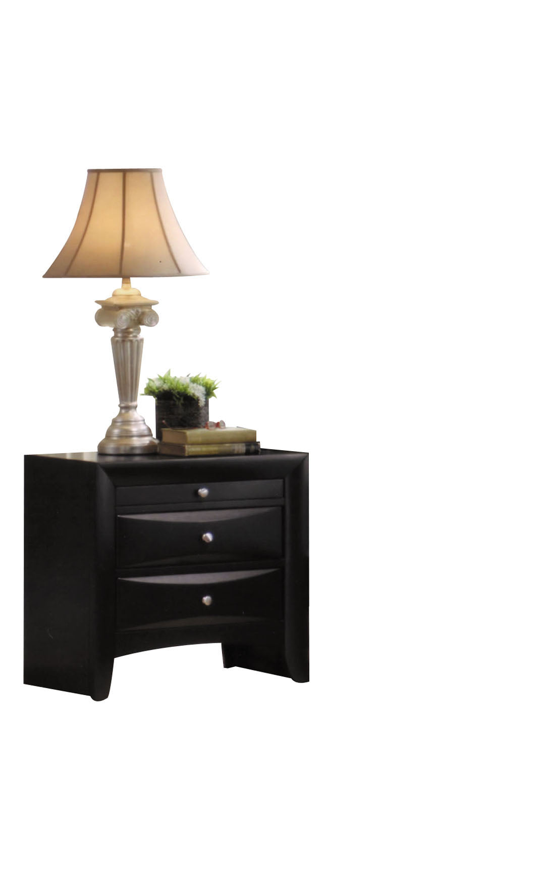 Sleek black nightstand with three drawers topped with a cream lampshade and decorative items