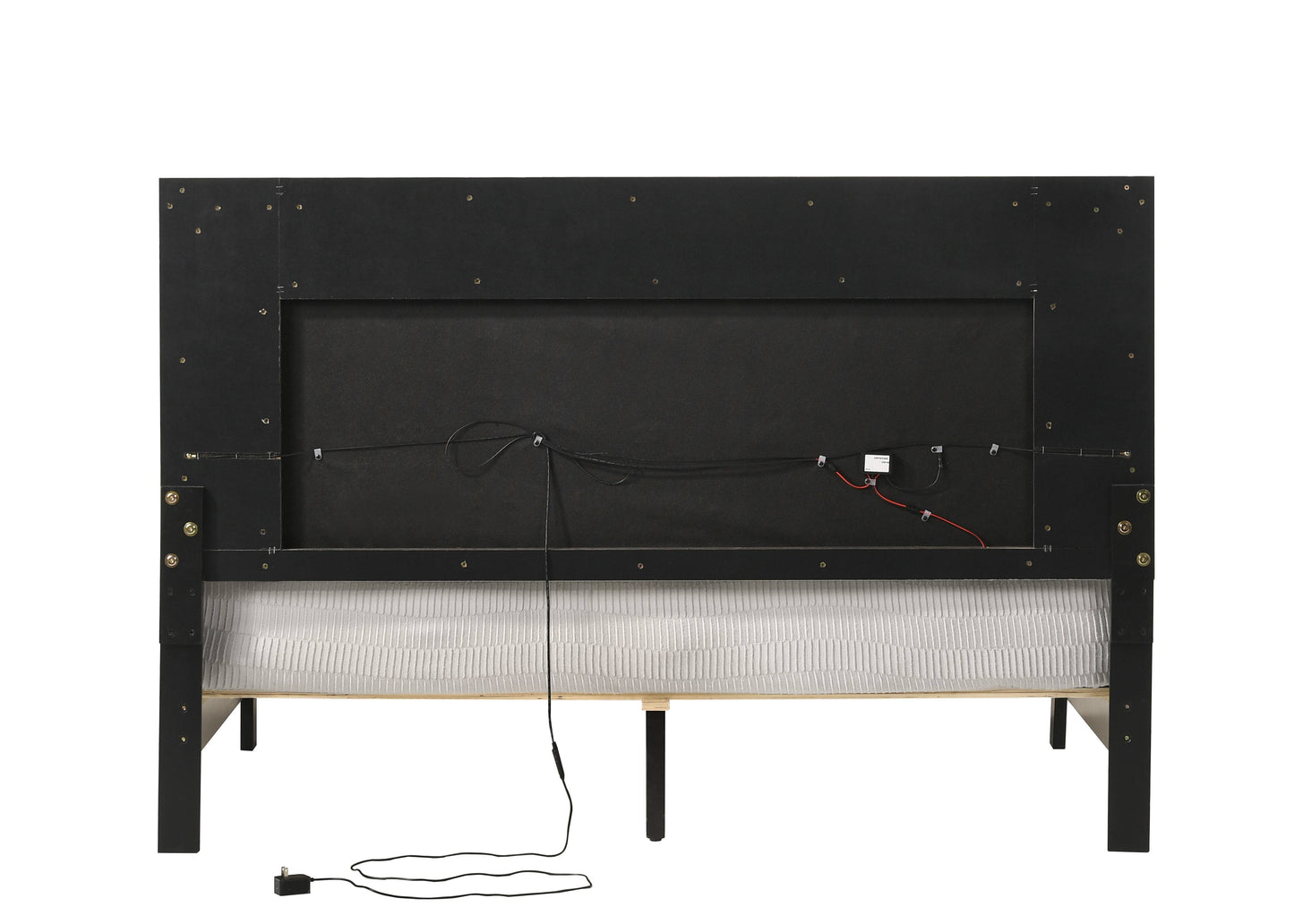 Back view of a black upholstered headboard with integrated LED lighting wires and a power adapter