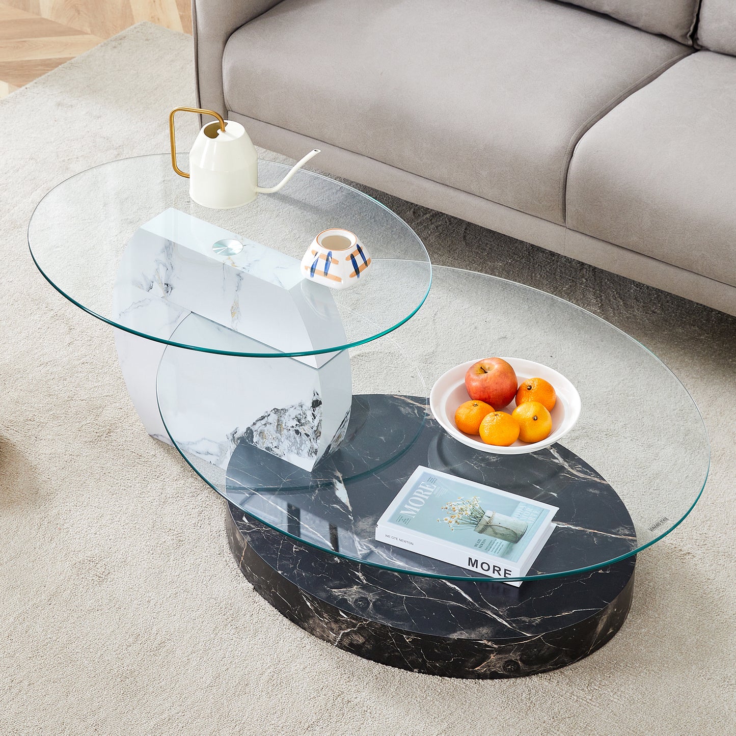 Modern oval coffee table with glass top and marble pedestal base