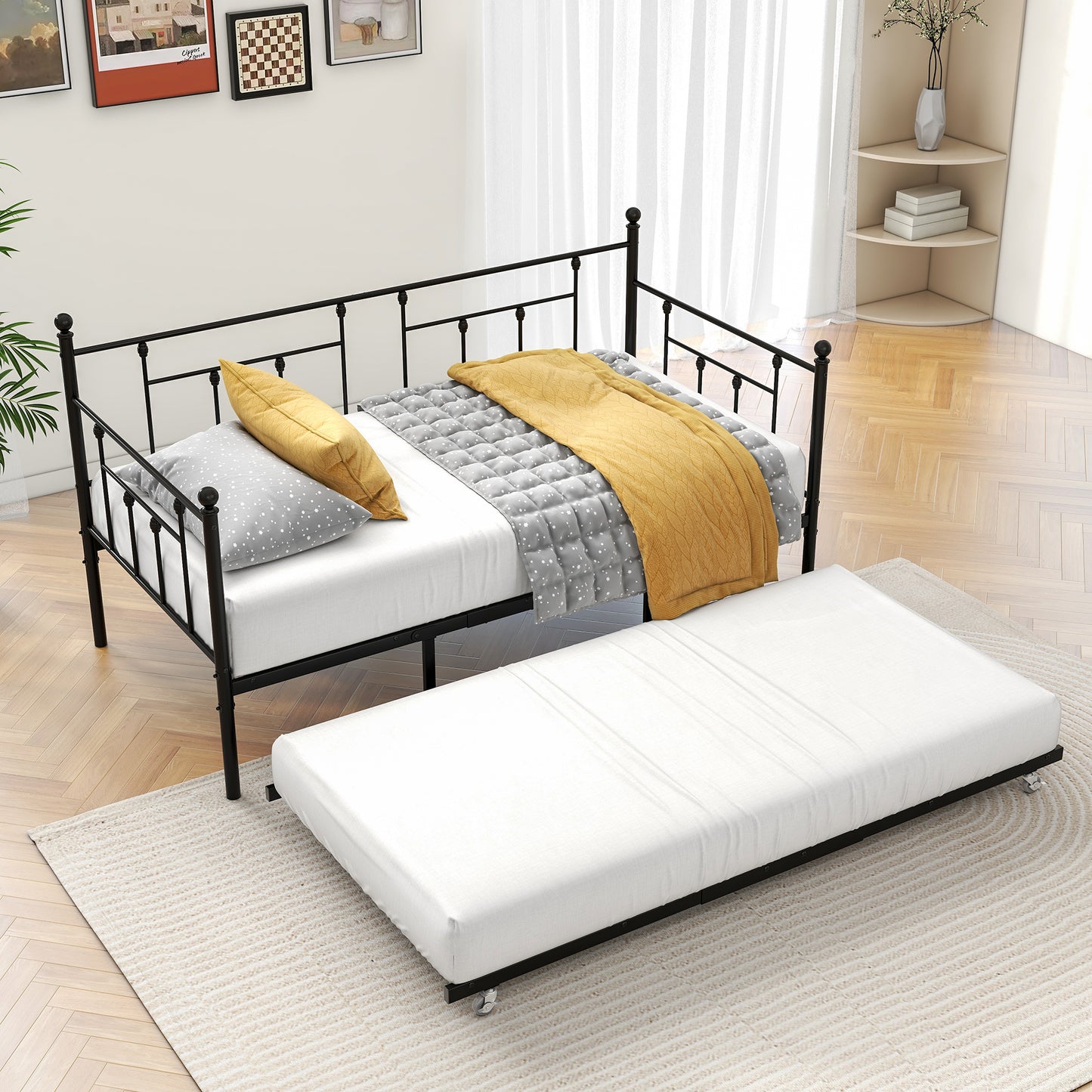 Black metal daybed with trundle featuring decorative finials and scrollwork Perfect for guest rooms
