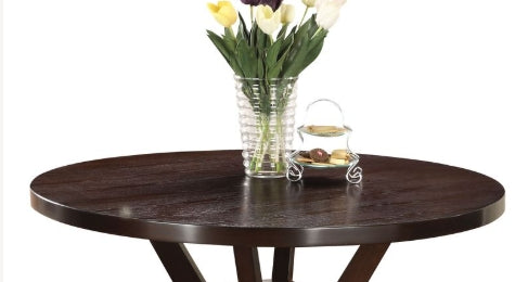 Dark brown round dining table with textured wood grain finish and sturdy Xleg base