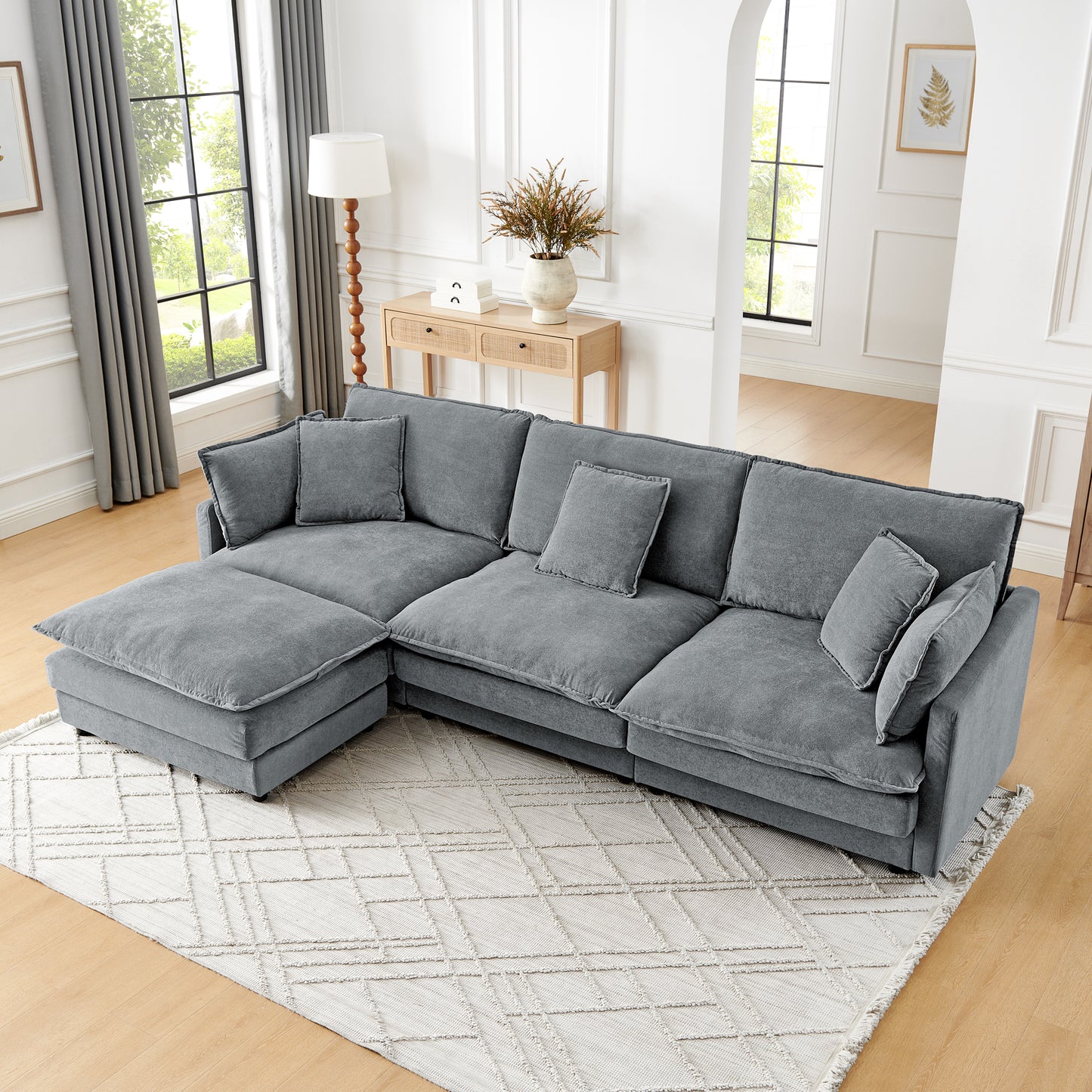 Plush grey fabric sectional sofa with chaise and accent pillows for comfortable living room seating
