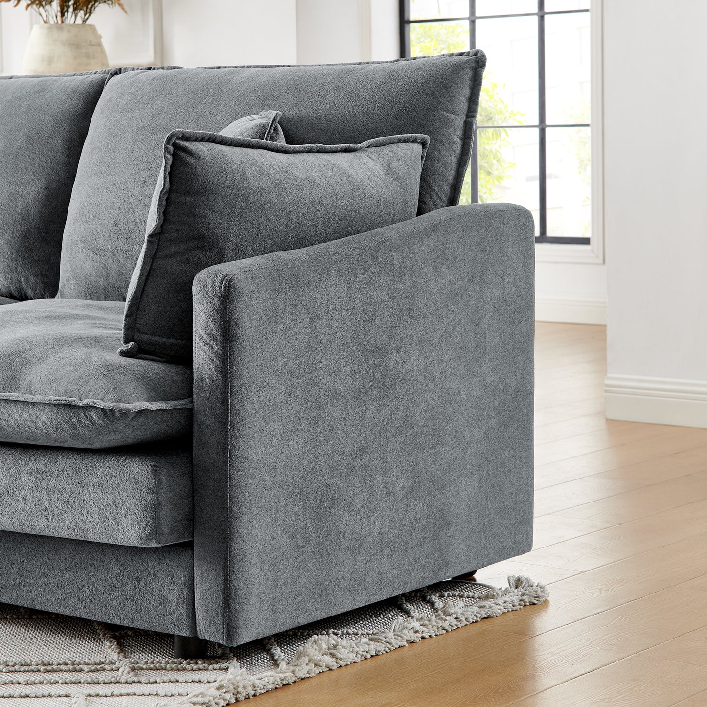 Plush grey fabric sectional sofa with deep seating and textured cushions perfect for modern living rooms