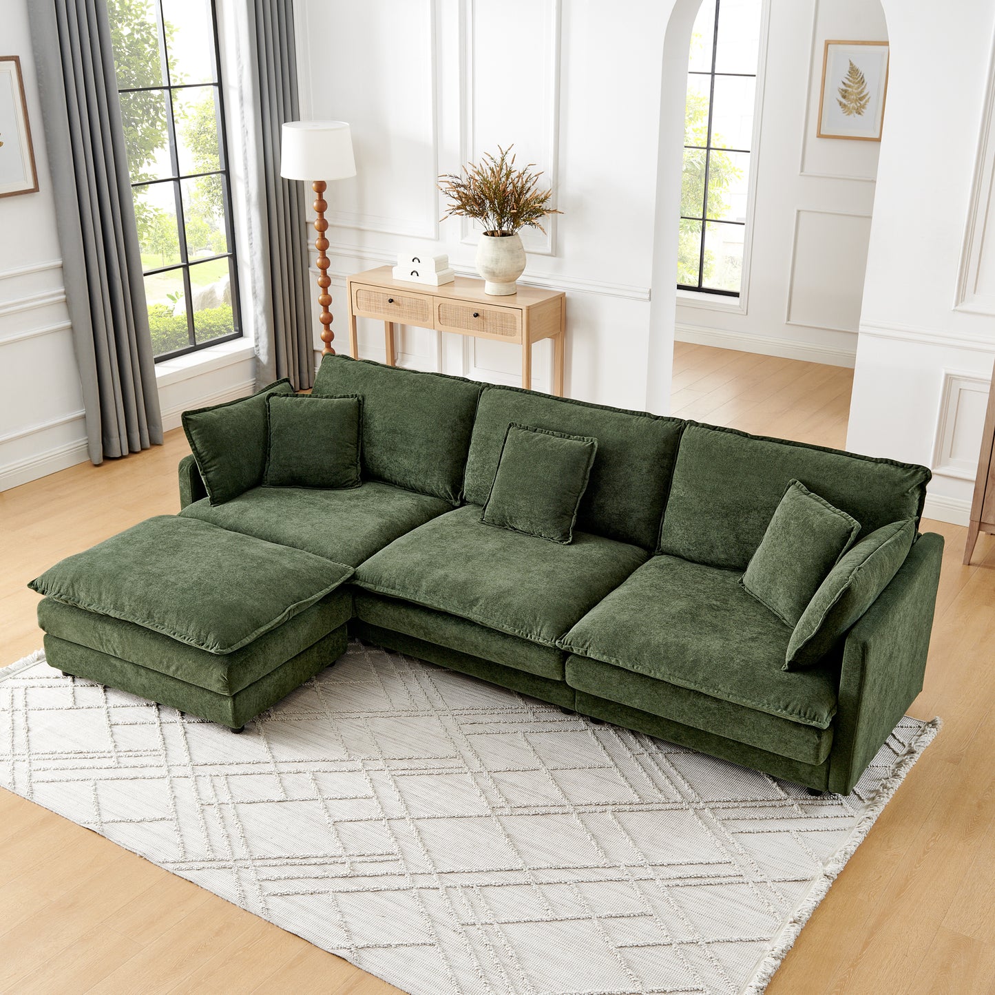 Plush green sectional sofa with chaise lounge and matching accent pillows perfect for modern living rooms
