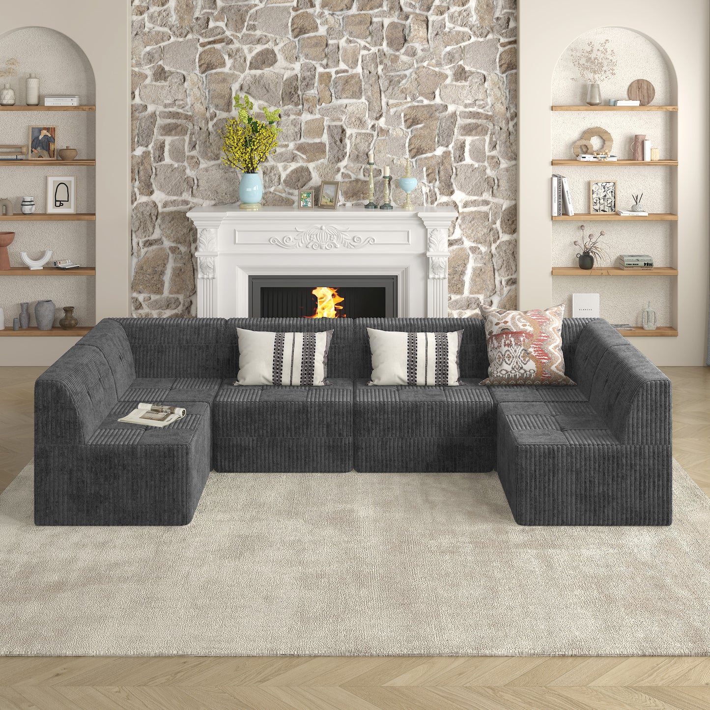 Dark gray corduroy sectional sofa with plush throw pillows and a magazine