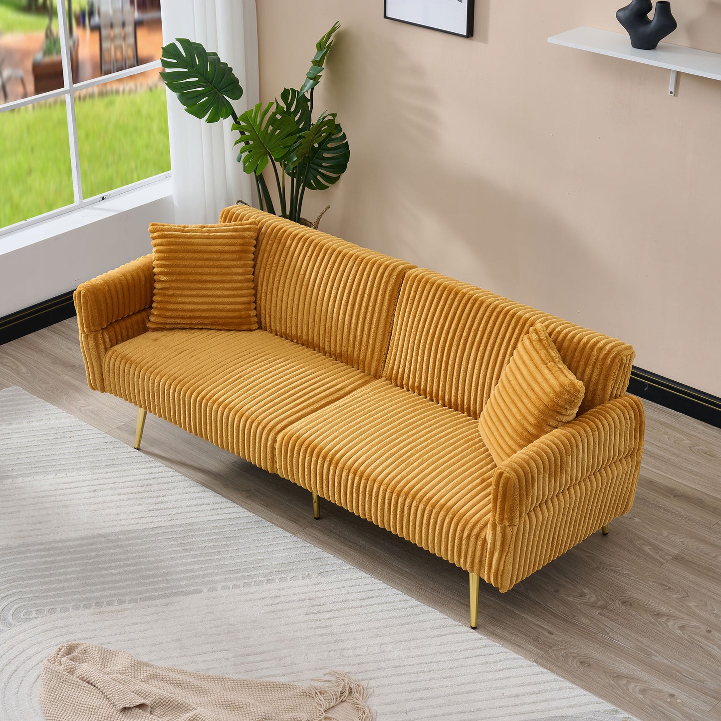 Mustard yellow corduroy sofa with textured cushions and gold legs perfect for modern living rooms
