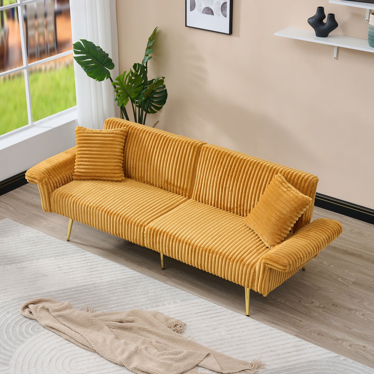 Mustard yellow corduroy sofa with channel tufting and two throw pillows