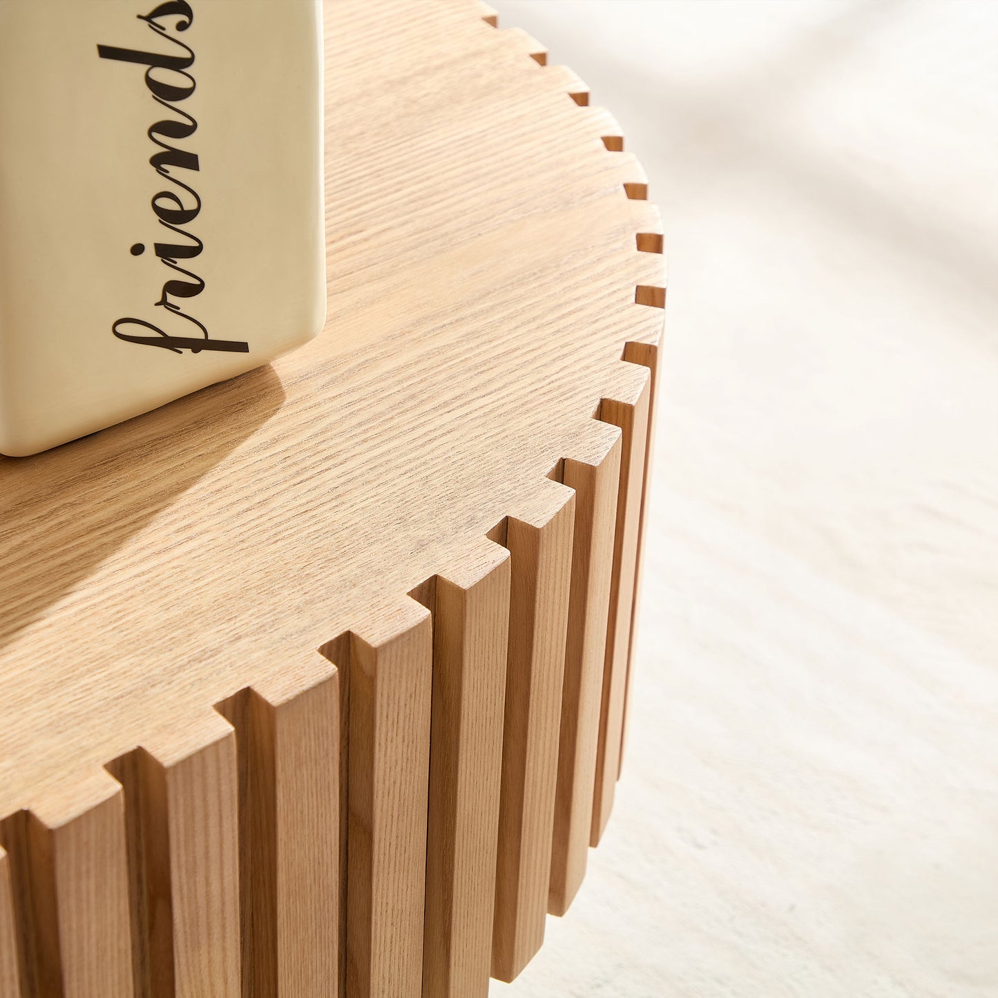 Textured oak side table with a unique fluted design and a ceramic vase