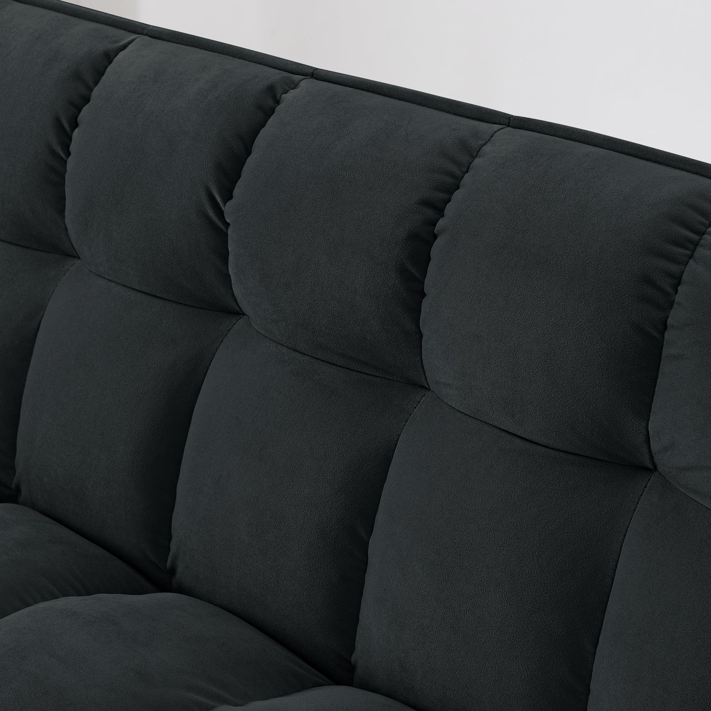 Closeup of tufted dark grey fabric sofa plush cushions for comfort
