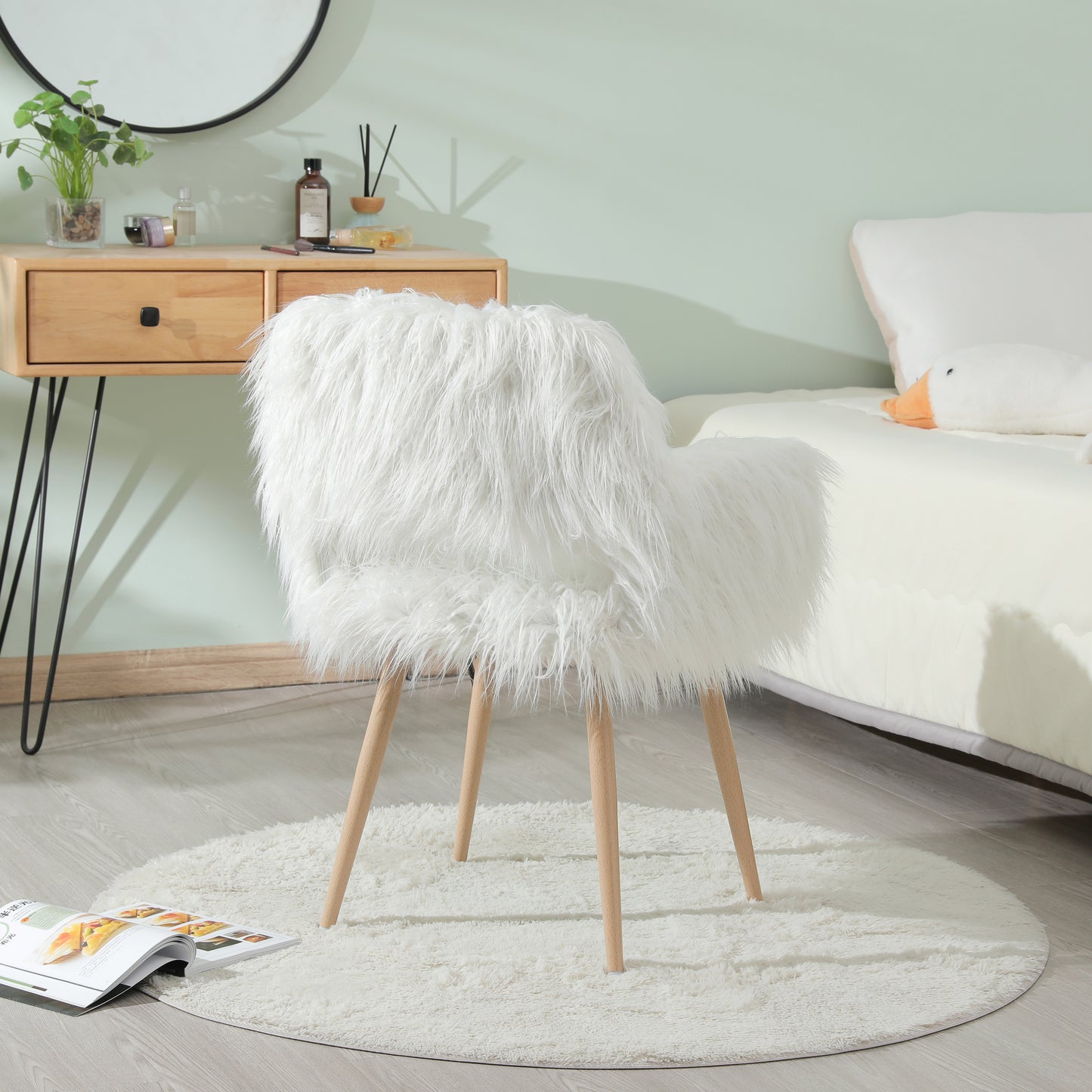 Fluffy white accent chair with natural wood legs perfect for a vanity or reading nook