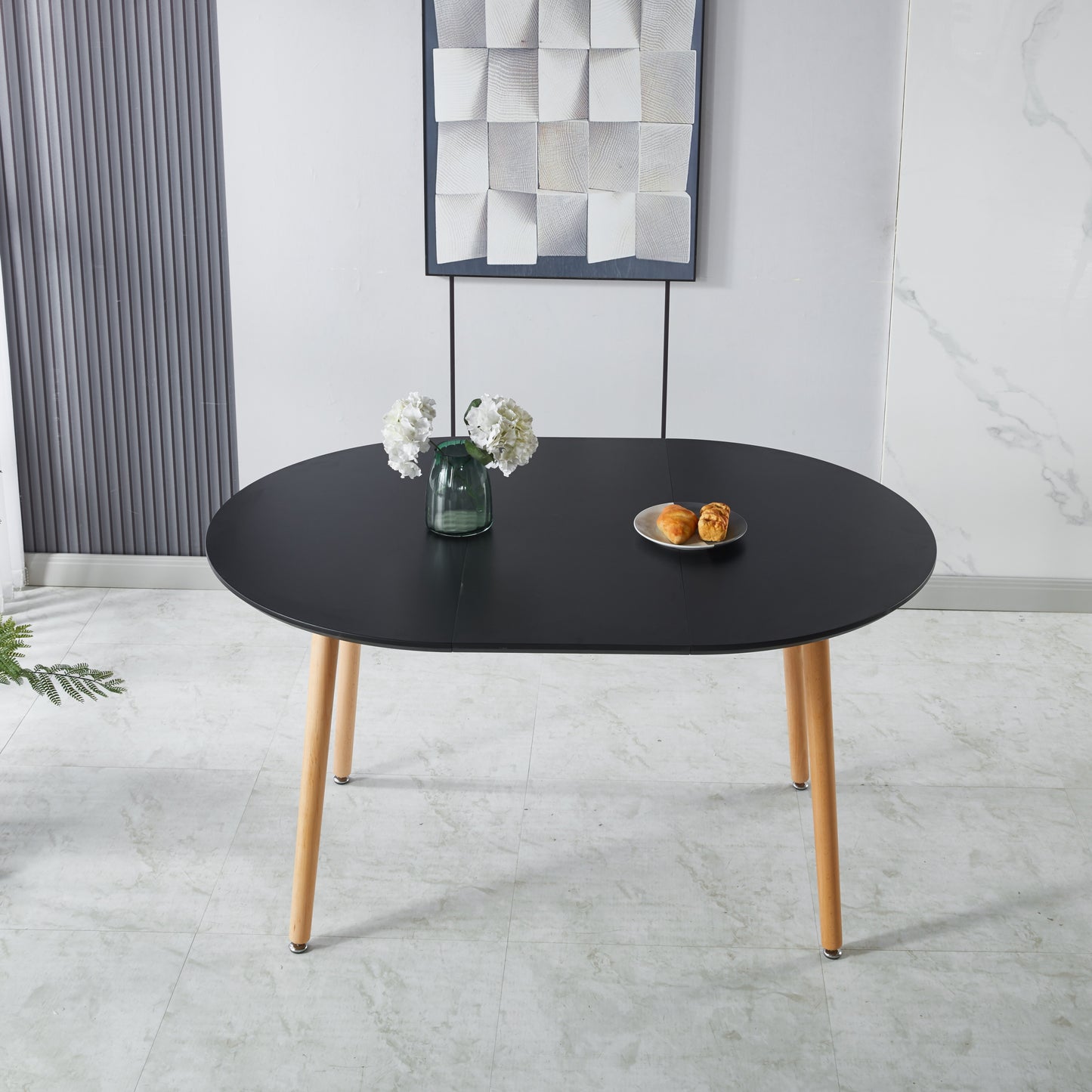 Black oval dining table with light wood legs featuring minimalist design for modern homes