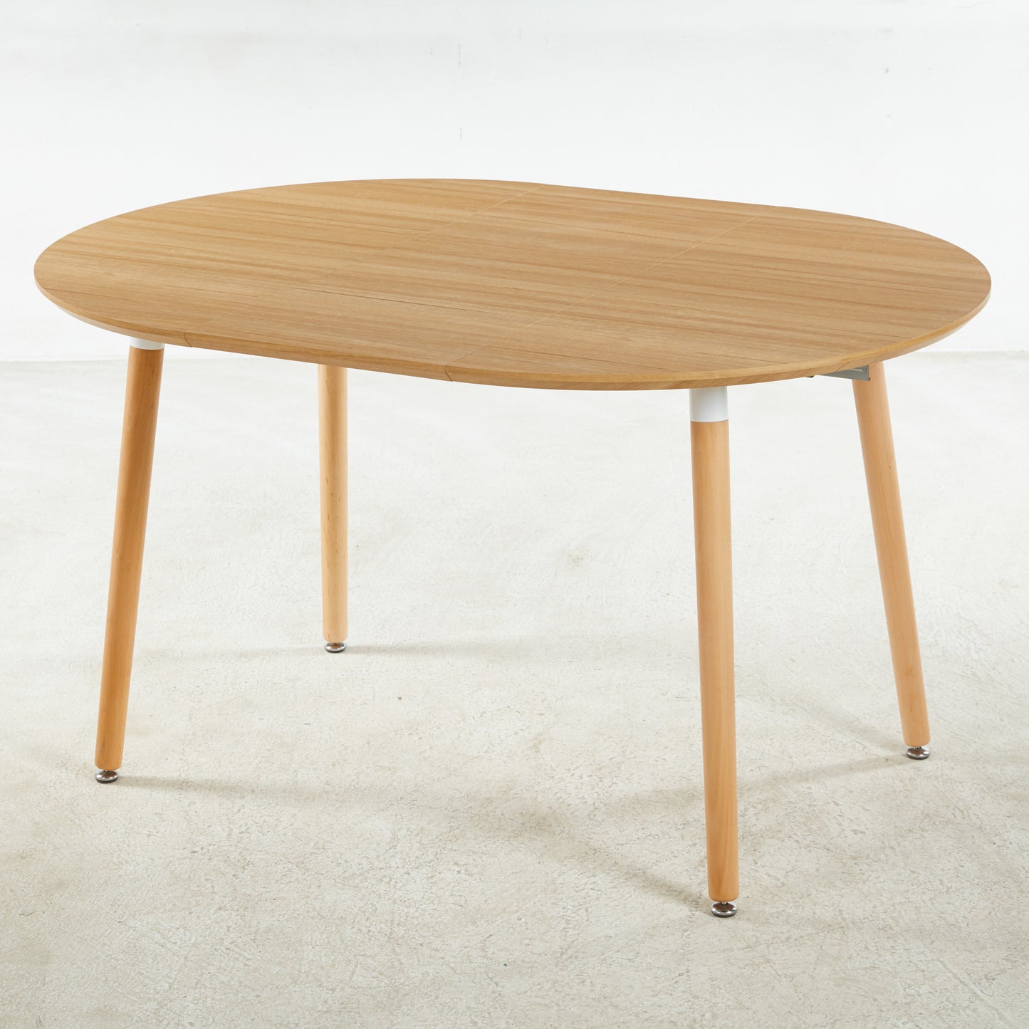Light wood oval dining table with tapered legs
