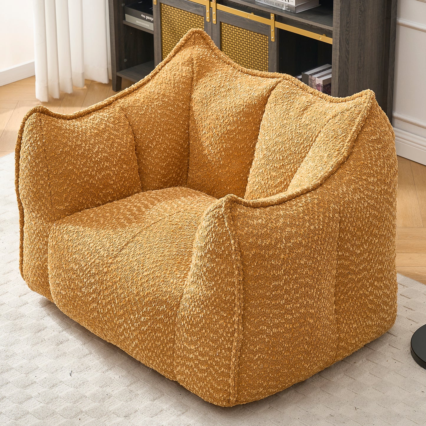 Plush mustard yellow boucle armchair with a unique rounded modern design and comfortable seating