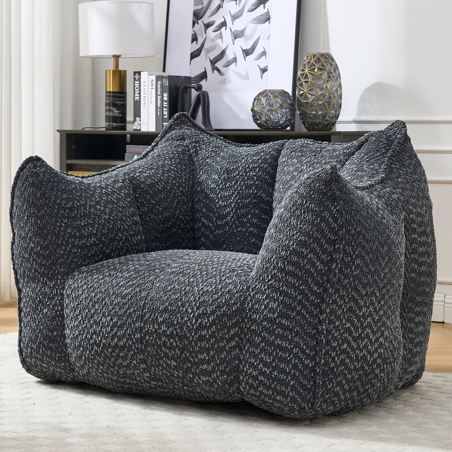 Plush charcoal boucle armchair with textured weave for cozy living room seating