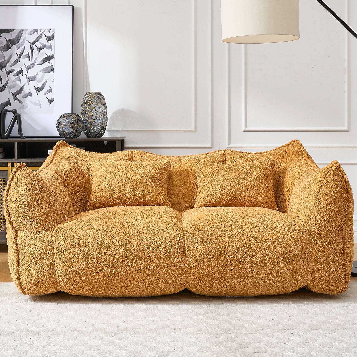 Plush mustard yellow boucle fabric sofa with two matching throw pillows for comfortable seating