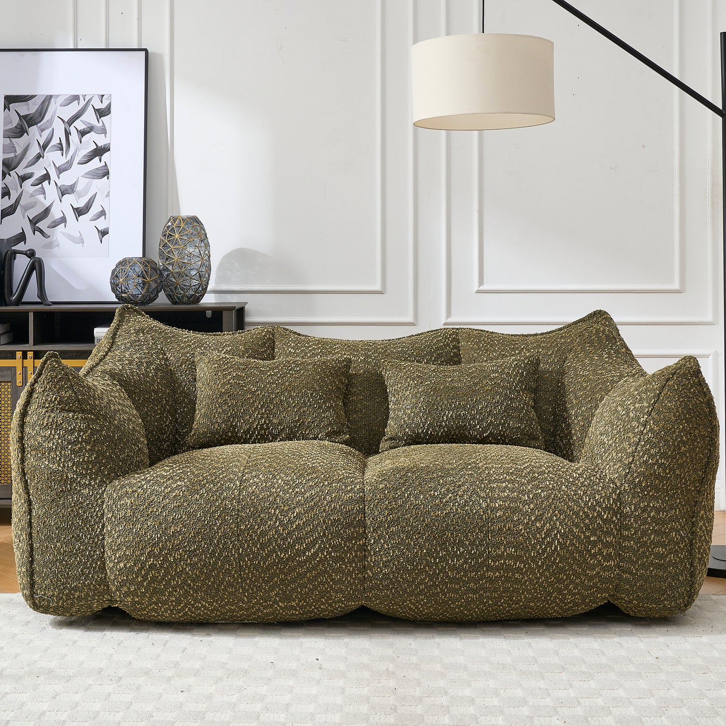 Textured green fabric couch with two accent pillows perfect for a modern living room