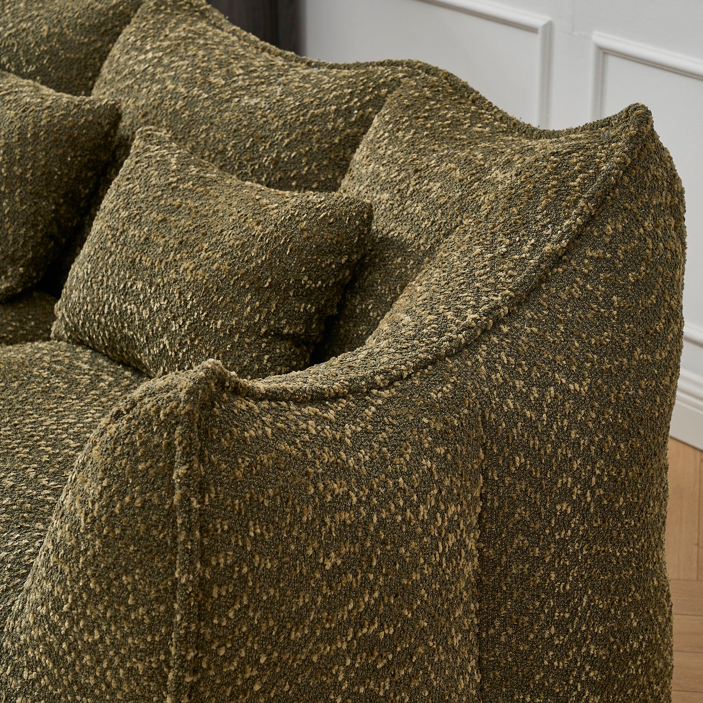 Textured olive green boucle fabric on a modern sofa