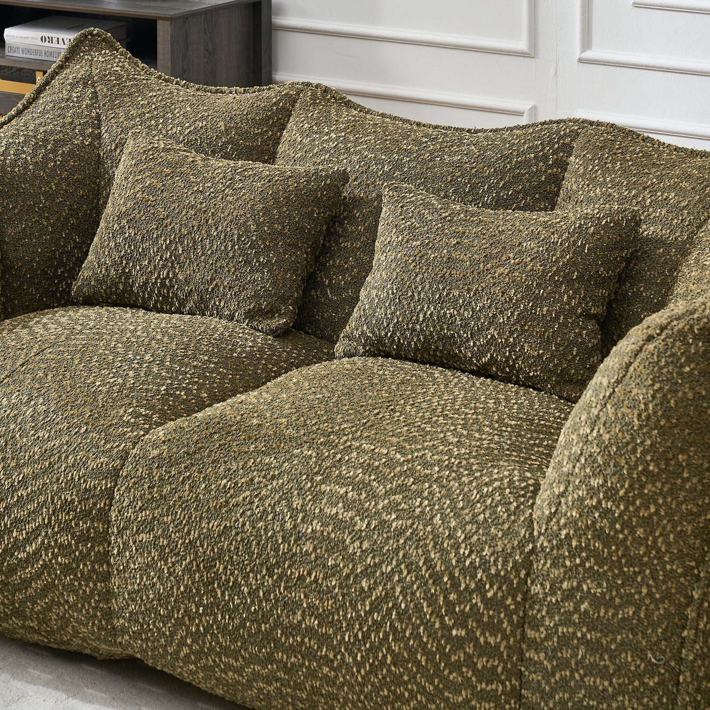 Textured olive green boucl fabric sofa with plush cushions perfect for living rooms