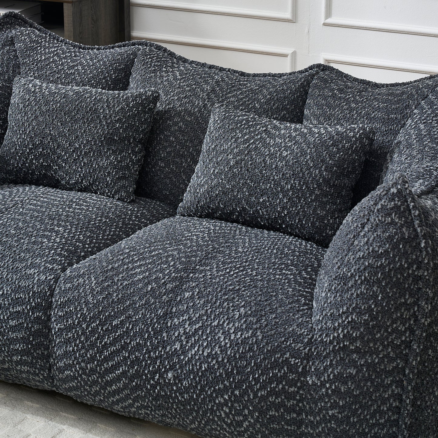 Textured dark grey boucl fabric sofa with plush cushions for ultimate comfort