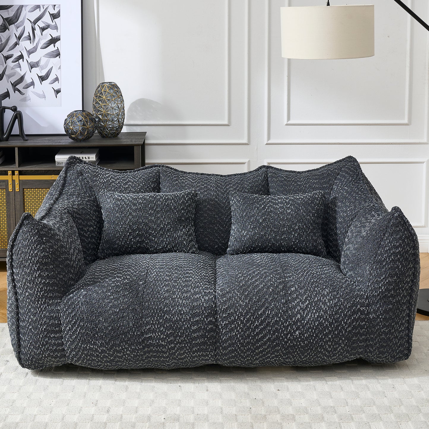 Plush charcoal grey boucle fabric sofa with textured cushions for ultimate comfort