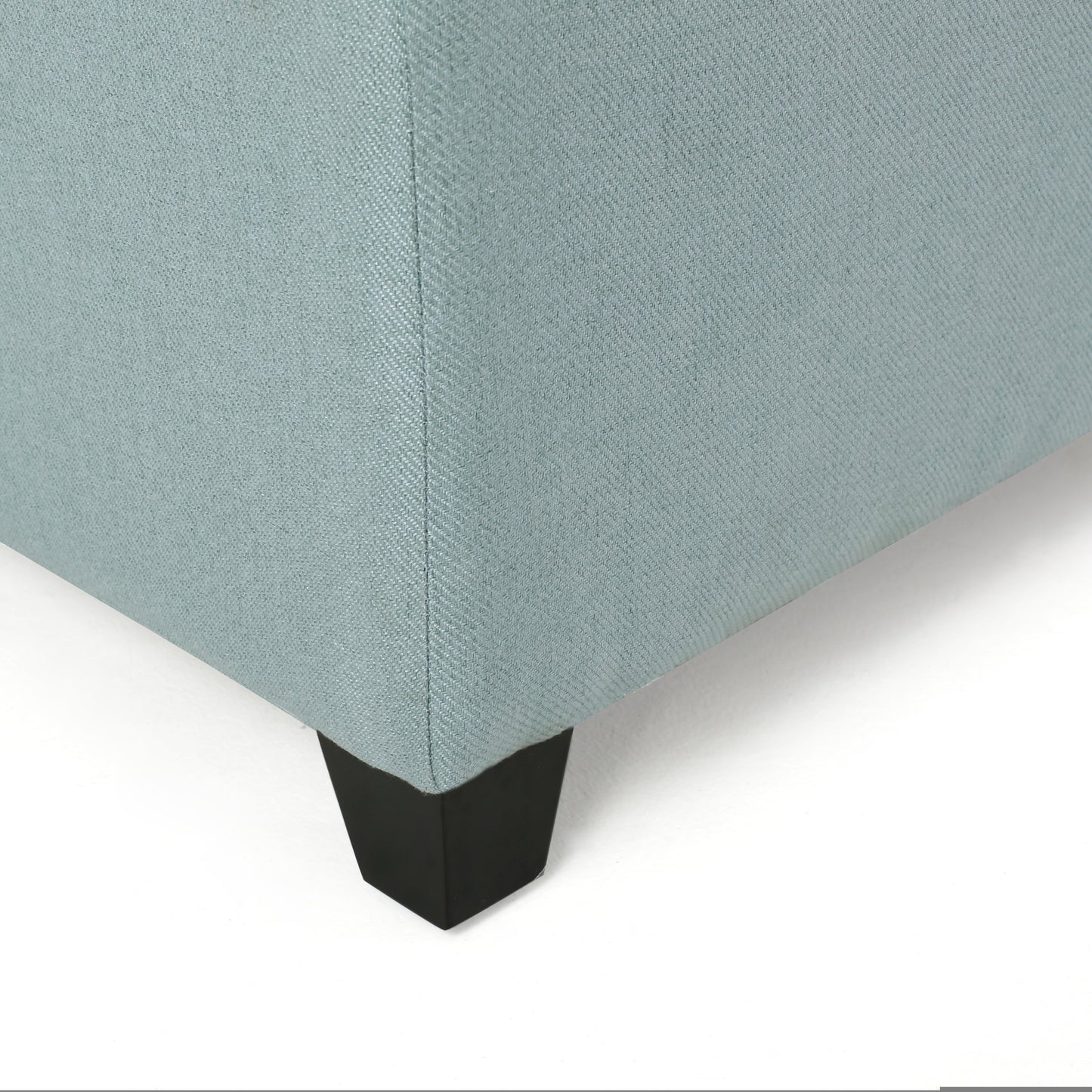 Light blue woven fabric ottoman corner with black tapered leg