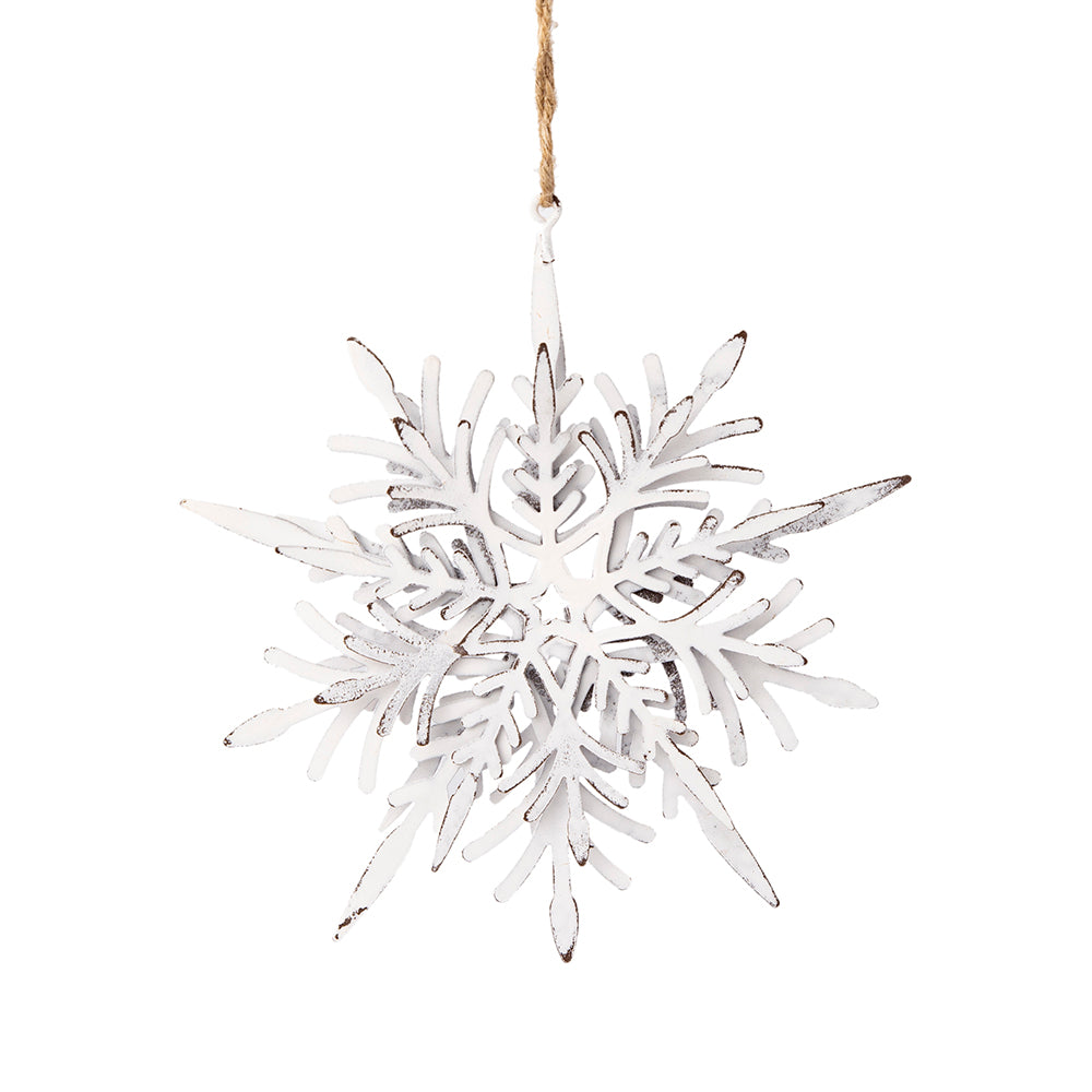 Distressed white metal snowflake ornament hanging on twine perfect for winter decor