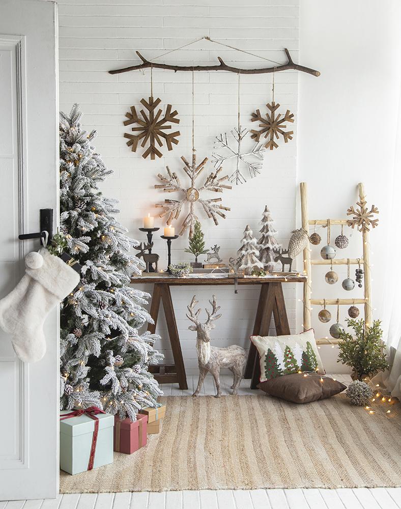 Flocked artificial Christmas tree with warm LED lights and rustic decor
