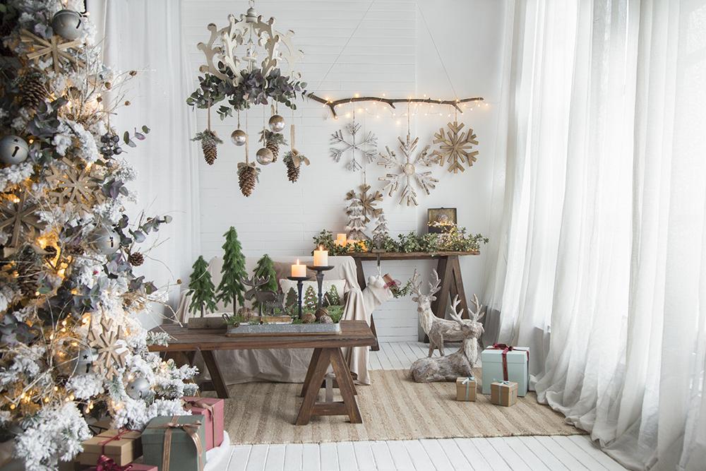 Flocked Christmas tree with wooden snowflakes and soft lights festive holiday decor