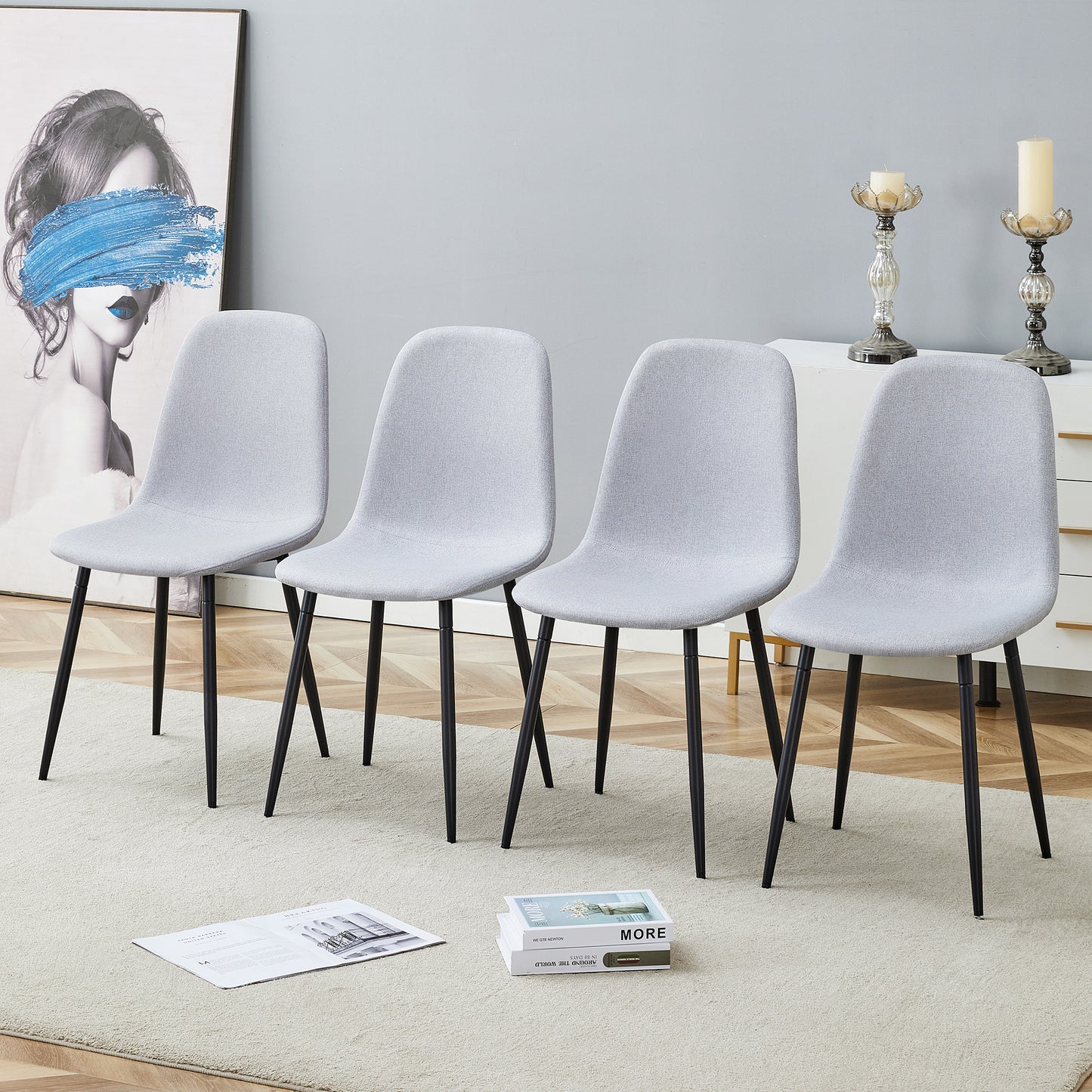 Four light grey fabric dining chairs with black metal legs modern style