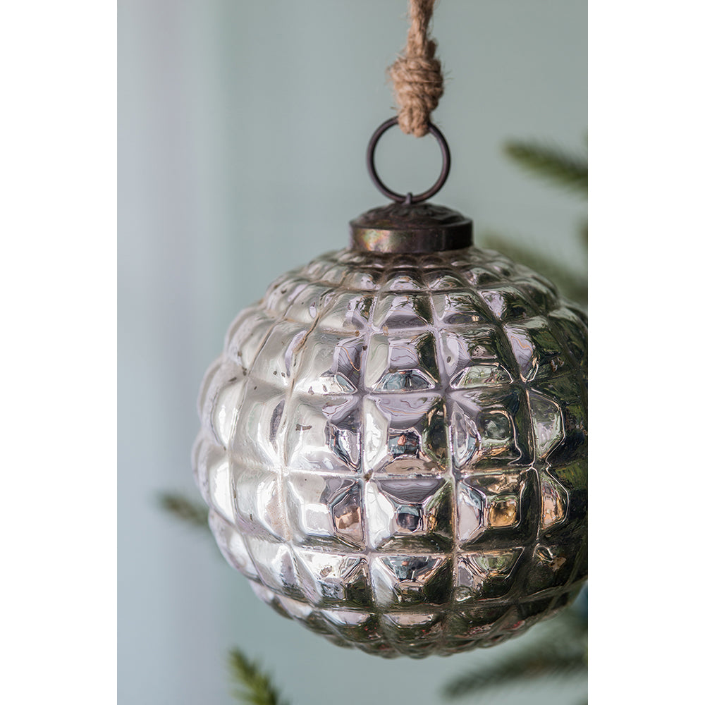 Textured antique silver glass Christmas ornament hanging from twine