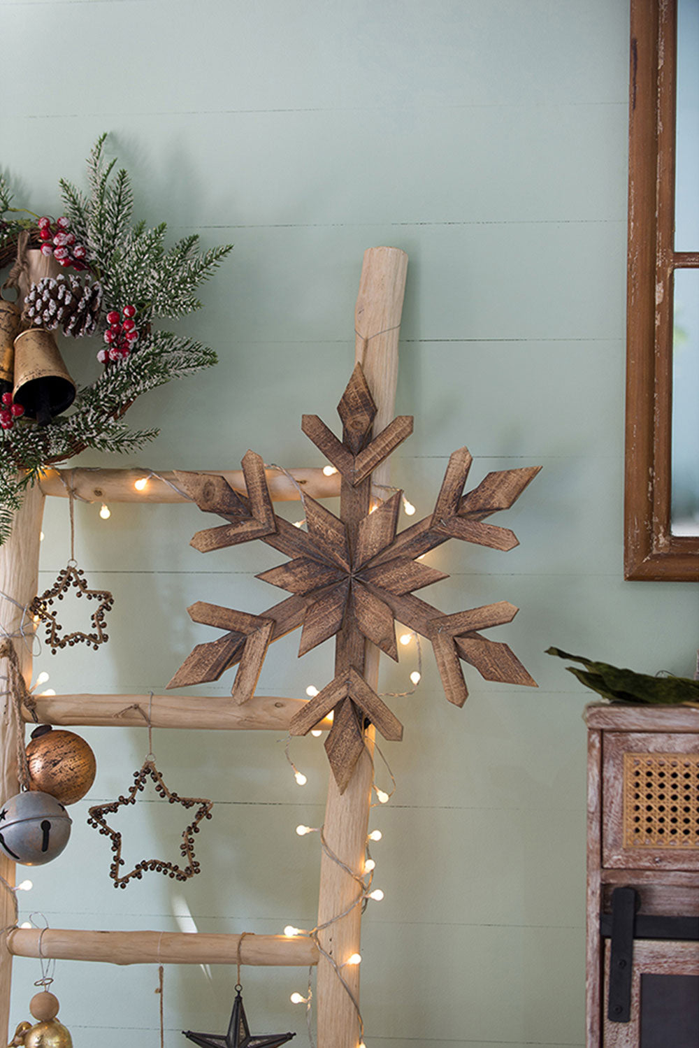 Rustic wooden snowflake decoration with pine cone accents ideal for rustic Christmas decor